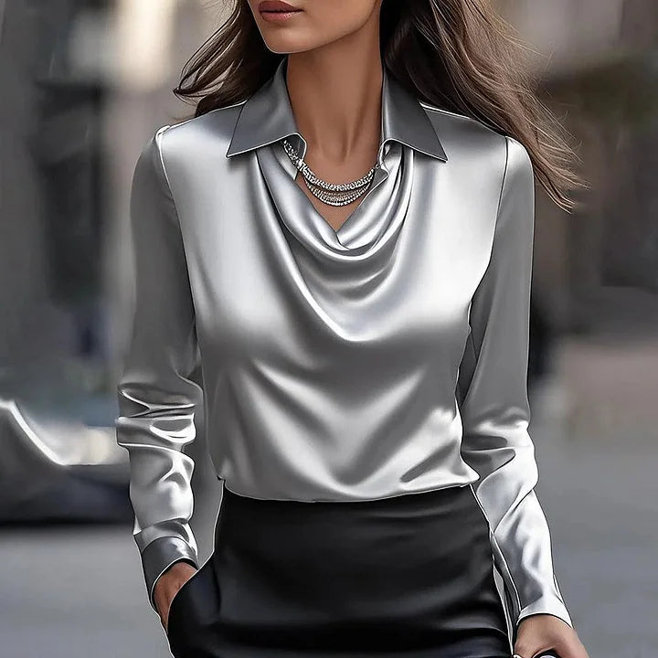 Milan draped neck blouse in metallic silver, front view with black skirt