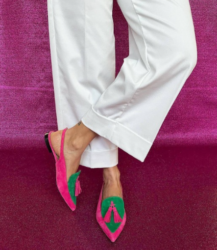 Elena slingback flats in fuchsia and green, worn with white wide-leg trousers
