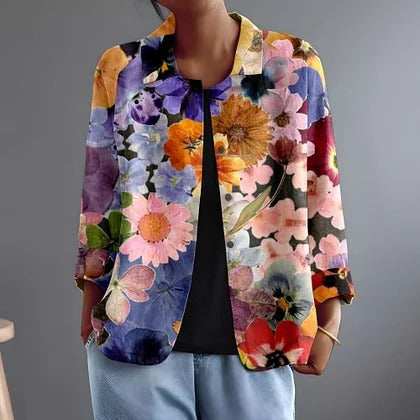 Marguerita blouse in multicoloured floral print, worn open over a black top, front view