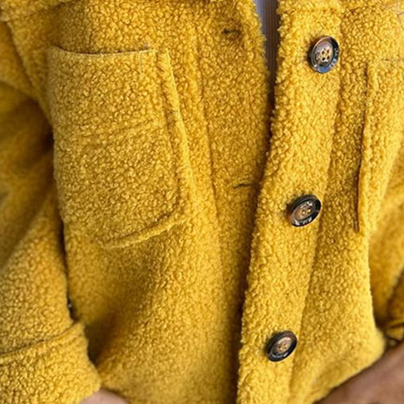Close-up of Laverinne jacket in yellow showing buttons and pocket