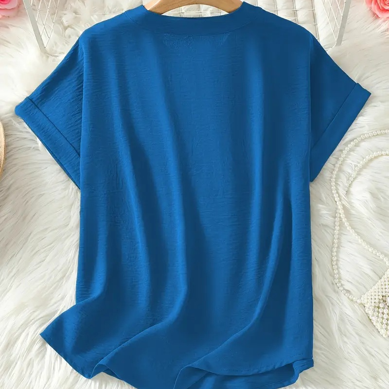 Livia blouse in deep blue laid flat, back view with curved hem