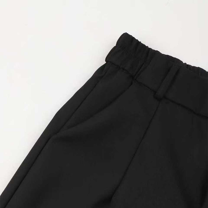 Margaret trousers in black, close-up of elasticated waistband and belt loop
