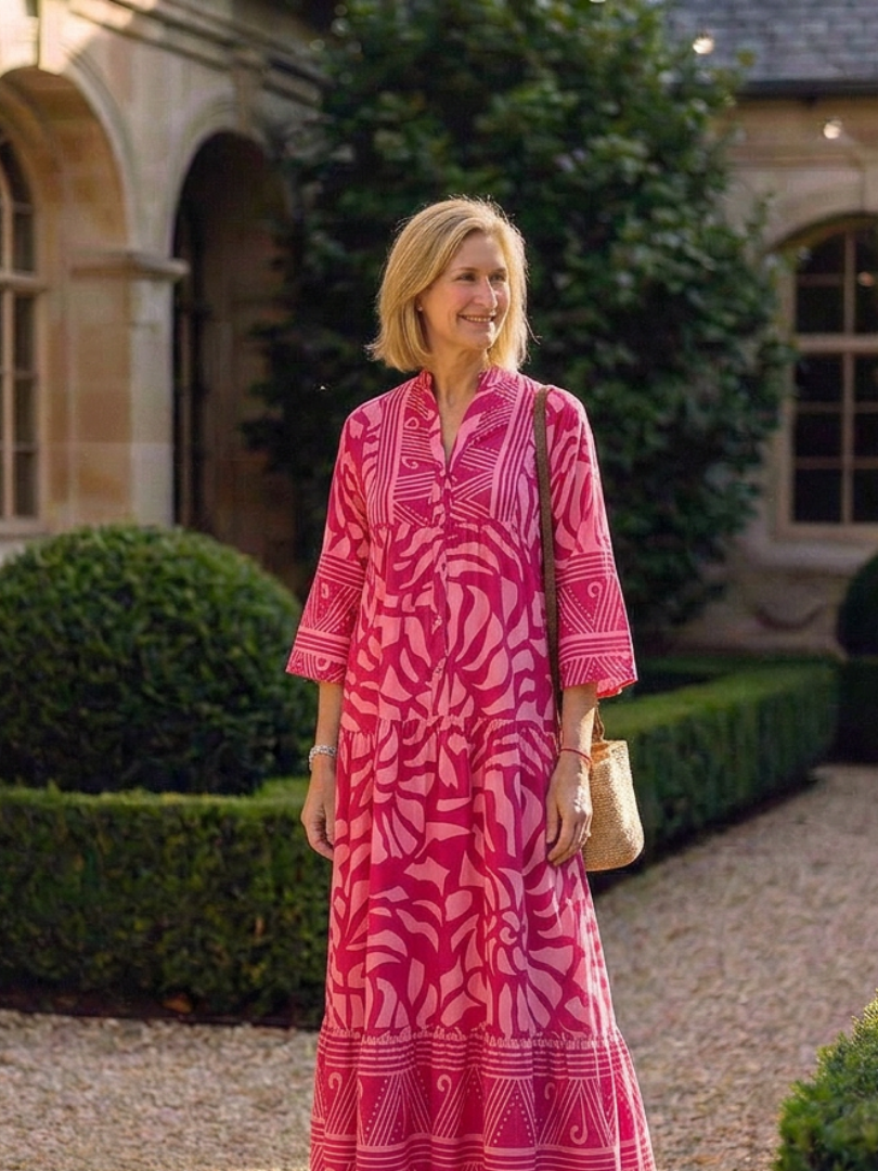 Marielle midi dress in pink worn in a garden setting