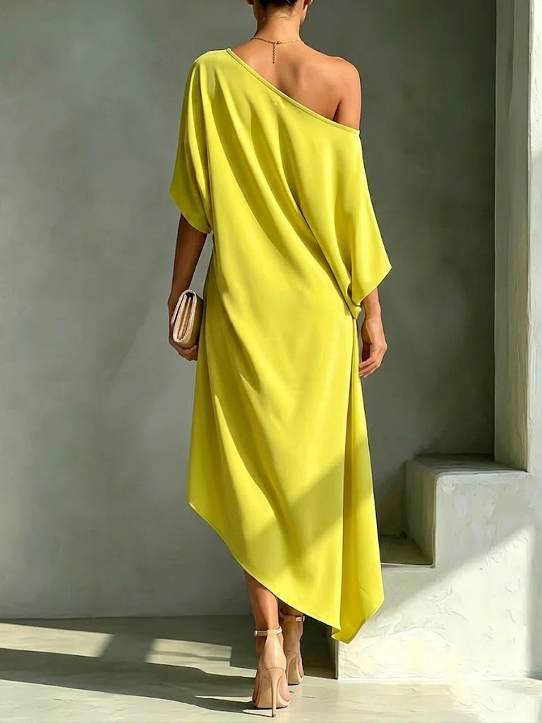 Camila asymmetrical midi dress in yellow, back view showing dipped hem