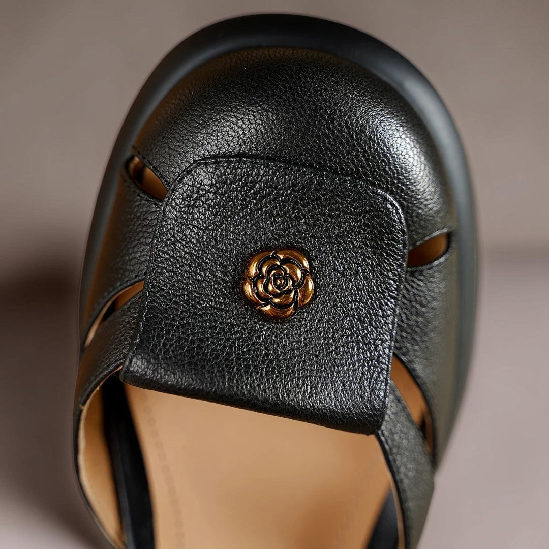 Claire sandals in black, close-up of gold rose toe detail