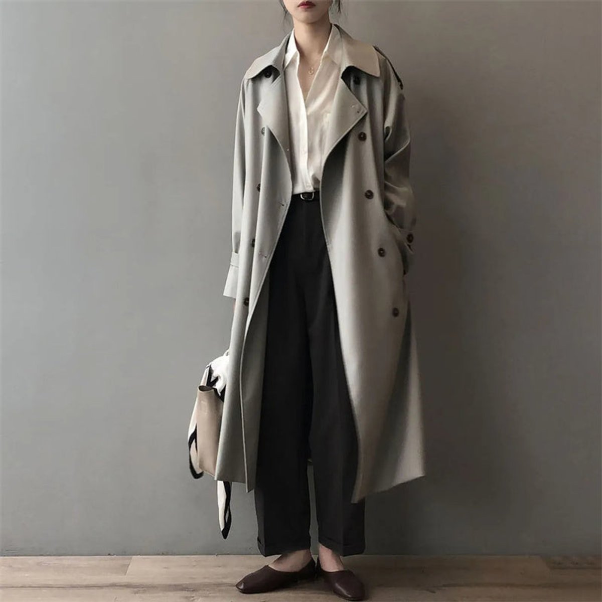 Katherine long double-breasted trench coat in grey, worn open over shirt and trousers