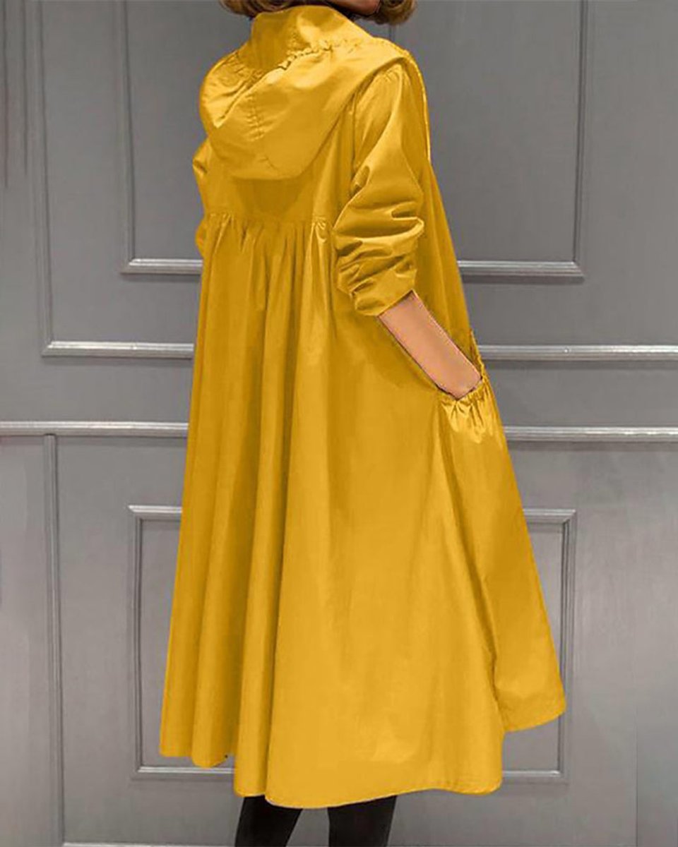 Kathleen long hooded trench coat in yellow, side view with hand in pocket