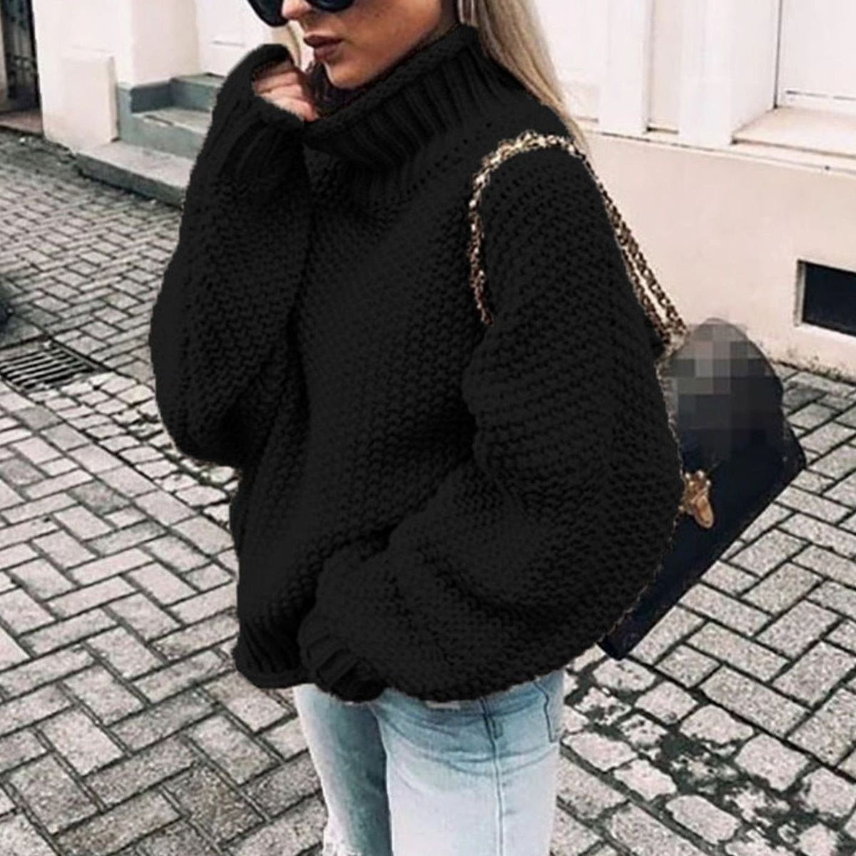 Oversized chunky knit turtleneck sweater in black, worn with jeans