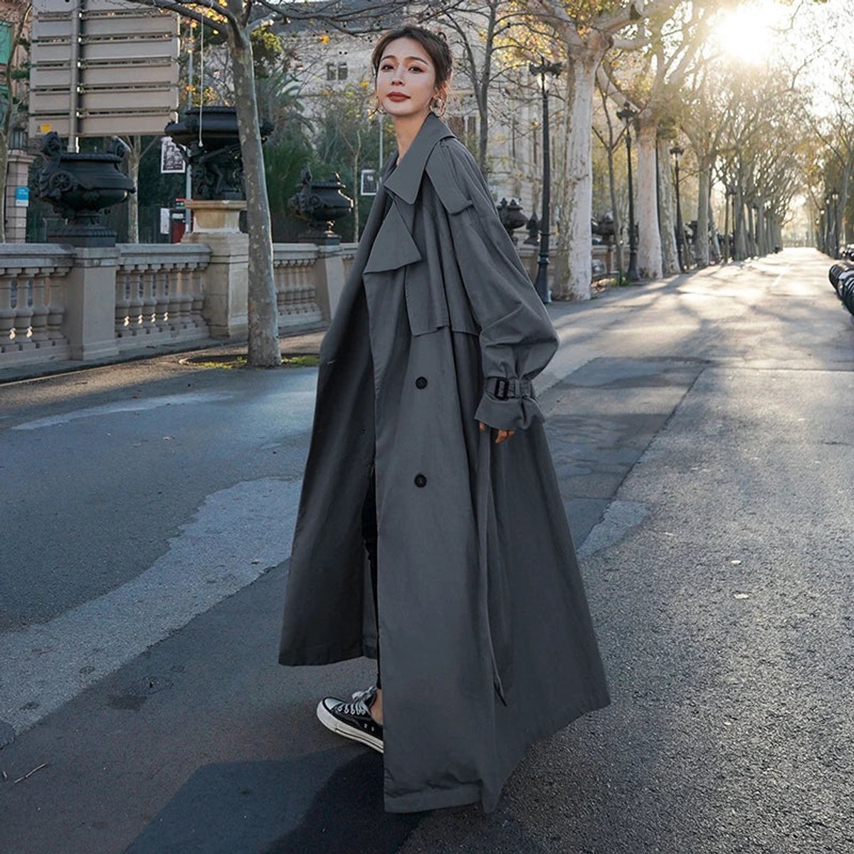 Kay oversized maxi trench coat in grey, full-length side view with buckled cuffs