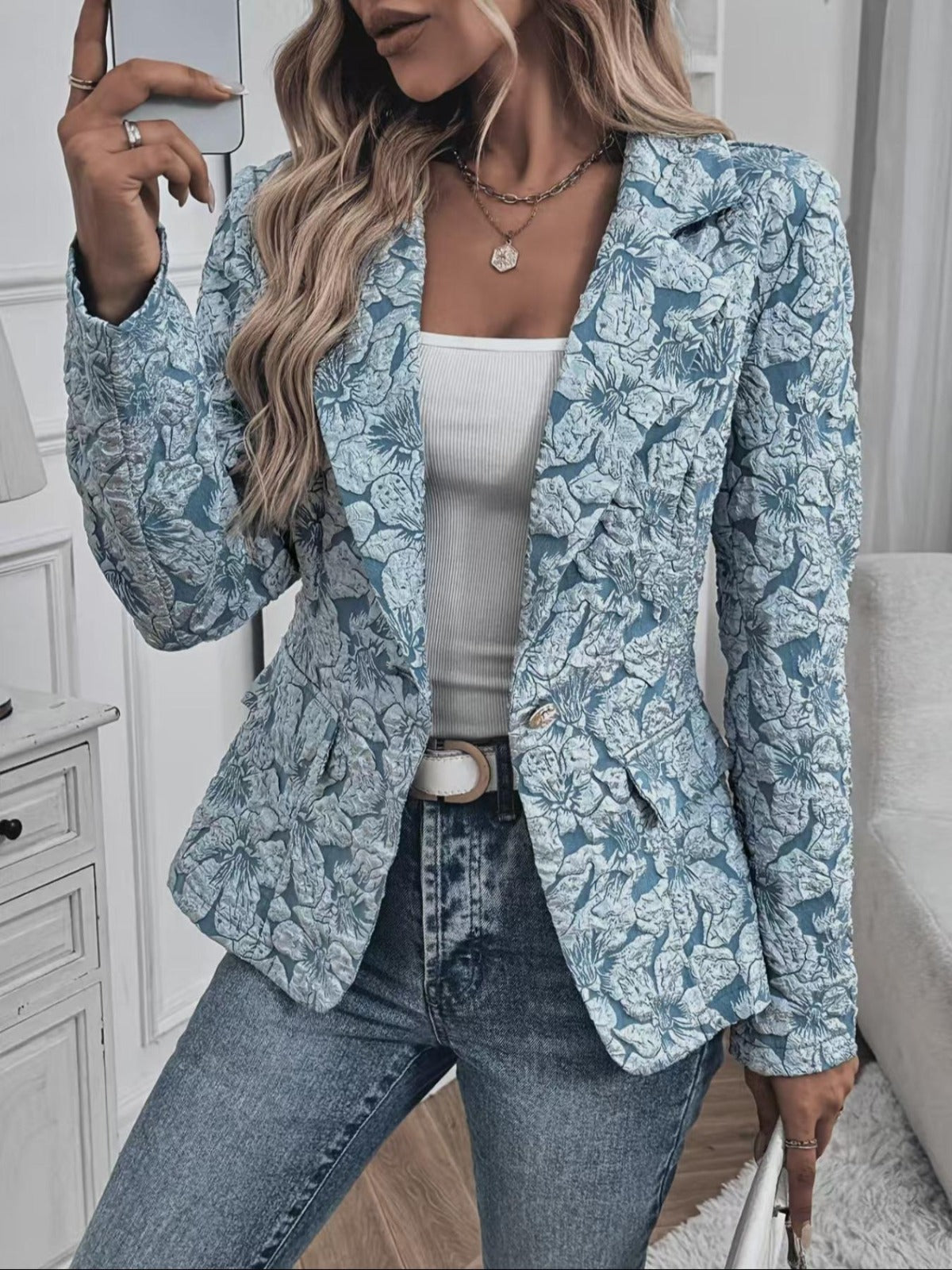 Loretta textured floral blazer in baby blue, front view with belt and jeans