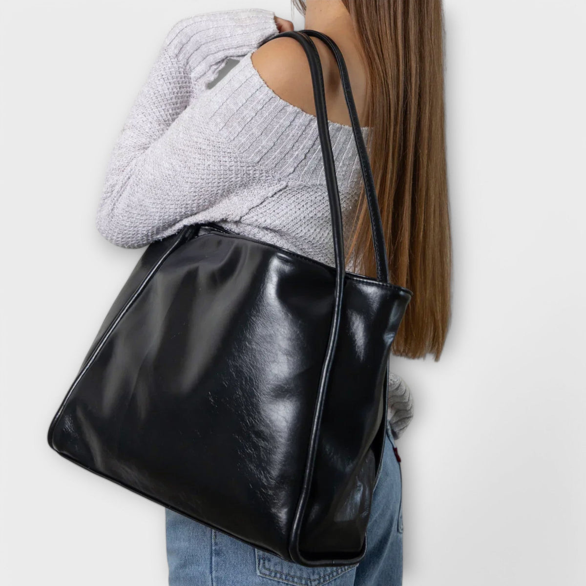Valerie Blair tote bag in black worn over the shoulder, side view